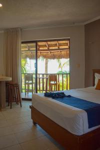 a bedroom with a large bed and a balcony at Tecnohotel Beach in San Benito