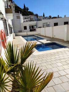 a swimming pool on the side of a building at Santo Cristo 11 in Frigiliana