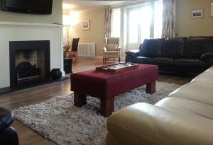 a living room with a couch and a coffee table at Gate lodge at Lough Erne Golf Village in Ballycassidy