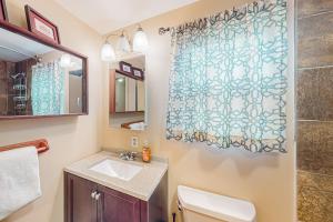 a bathroom with a sink and a shower curtain at Little Sand Creek Chalet in Sandpoint +33 photos