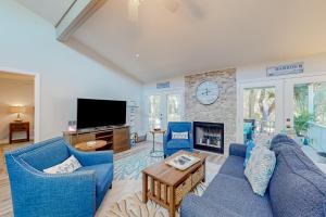 a living room with a blue couch and a fireplace at The Harbour Home in St. Augustine