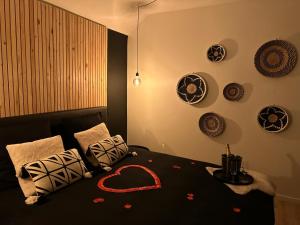 a bedroom with a bed with a heart on it at Suite Marie in Verviers
