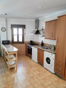 a kitchen with a sink and a washing machine at Santo Cristo 11 in Frigiliana
