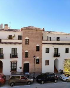 a group of cars parked in front of a building at Santo Cristo 11 in Frigiliana