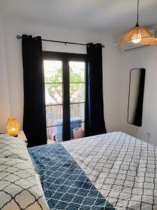 a bedroom with a large bed and a window at Santo Cristo 11 in Frigiliana