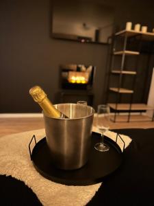 a metal bucket on a table with a bottle in it at Suite Marie in Verviers