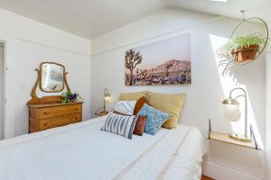 a white bedroom with a bed and a mirror at Hygge House in Berkeley