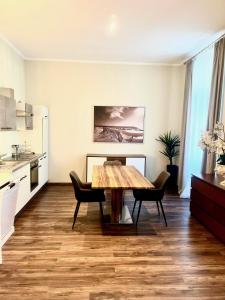 a kitchen and dining room with a table and chairs at Appartements in Wienerwald Residenz in Baden