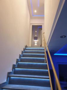 a blue staircase in a building with blue ceilings at Ferienwohnung in Würzburg heidingsfeld in Würzburg