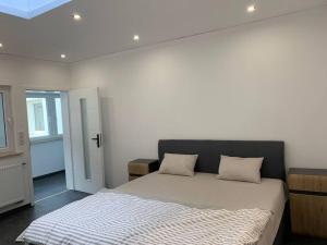 a bedroom with a bed with two pillows on it at Ferienwohnung in Würzburg heidingsfeld in Würzburg