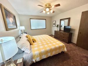a bedroom with a bed and a ceiling fan at Beautiful and Spacious Marion IA Apartment. in Marion
