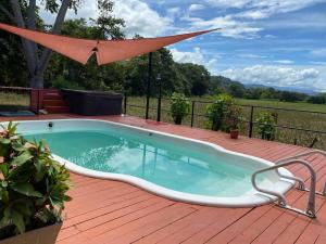 a hot tub on a deck with an umbrella at Family-sized Beach Suite in Playa Matapalo in Savegre