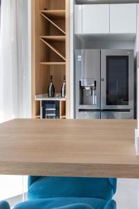 a kitchen with a wooden table and a refrigerator at Modern apartment in the center of St Julians in St Julian's