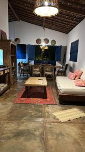 a living room with a couch and a table at Casa da Madame in São Miguel do Gostoso
