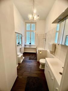 a bathroom with a sink and a toilet and a window at Appartements in Wienerwald Residenz in Baden