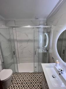 a bathroom with a shower and a toilet and a sink at Mar y Sol en El Médano, Tenerife Sur in El Médano