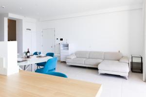 a living room with a couch and a table and chairs at Modern apartment in the center of St Julians in St Julian's
