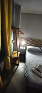 a bedroom with a bed and a table and a window at Trebis in Naples +12 photos