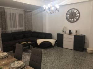 a living room with a couch and a clock on the wall at Beautiful,central, two bedrooms apartment in Castello in Castellón de la Plana