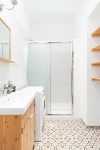 a bathroom with a shower and a sink at Eclectic Apartment in Vršovice by Prague Days in Prague