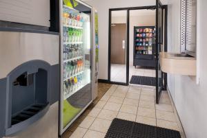 a refrigerator filled with lots of drinks in a store at Knights Inn Grand Rapids East Airport in East Grand Rapids