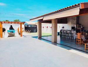 an outdoor patio with a swimming pool and a house at Império D in Tanabi