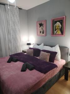 a bedroom with two beds and two pictures on the wall at Skitnica Marilyn in Koprivnica