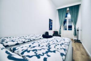 a bedroom with a bed with a blue and white blanket at Modern Double room JS b in Vienna