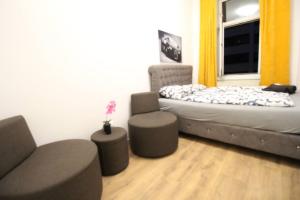 a bedroom with a bed and a chair and a window at Modern Double room JS b in Vienna