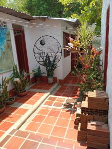 a patio with plants and a painting on the wall at Hostal ROLLED in Villavieja