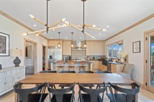 a dining room and kitchen with a wooden table and chairs at Sweetgrass Getaway in Blowing Rock