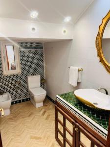 a bathroom with a sink and a toilet and a mirror at Villa Kimia Elfeige in Marrakesh +21 photos