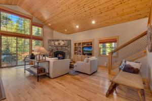 a living room with a staircase and a fireplace at Woodcrest at Tahoe Donner 3BR with Pool Table - 3000 sq ft in Truckee