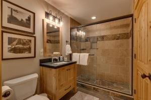 a bathroom with a shower and a toilet and a sink at Woodcrest at Tahoe Donner 3BR with Pool Table - 3000 sq ft in Truckee +15 photos