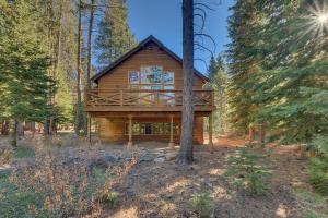 a log cabin in the woods with trees at Woodcrest at Tahoe Donner 3BR with Pool Table - 3000 sq ft in Truckee