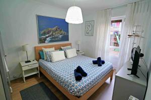 a bedroom with a bed with black shoes on it at Apart 2 terrazas para 4 personas Bilbao centro in Bilbao