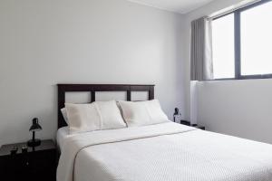 Rúm í herbergi á San Miguel Awanka Hotel