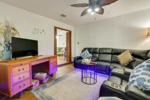 a living room with a couch and a flat screen tv at San Antonio Vacation Rental about 15 Mi to Downtown! in San Antonio