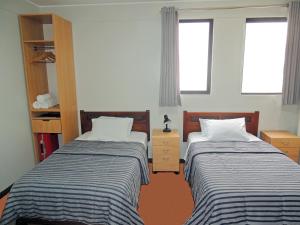 Rúm í herbergi á San Miguel Awanka Hotel