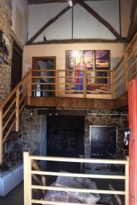 a living room with a staircase and a fireplace at Casa-museo Genia Trigo in Sober