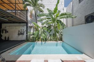 a swimming pool in a building with plants at El Refugio de Sayulita - Health and Wellness House in Sayulita