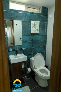 a bathroom with a toilet and a sink at Beachfront Vacation Villa 