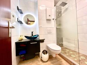 a bathroom with a toilet and a sink at The Stylish&Cozy Apartment with 37㎡ in District 1 in Düsseldorf