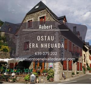 a building with a sign on the side of it at Alojamiento Rural Ostau Era Nheuada in Aubert