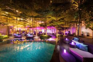 a swimming pool in a hotel with purple lighting at DoubleTree by Hilton Jakarta - Diponegoro in Jakarta