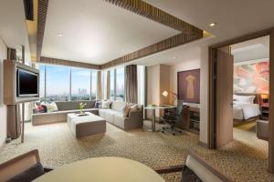 a large hotel room with a living room at DoubleTree by Hilton Jakarta - Diponegoro in Jakarta