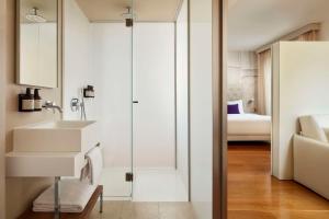 a bathroom with a sink and a mirror at Avani Palazzo Moscova Milan Hotel -Previously NH Palazzo Moscova- in Milan