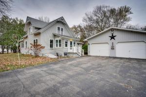 a white house with a garage and a driveway at Family-Friendly Home in Pepin Walk to Main St! in Pepin