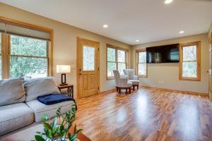 a living room with a couch and wooden floors at Family-Friendly Home in Pepin Walk to Main St! in Pepin