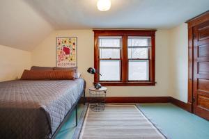 a bedroom with a bed and a window at Family-Friendly Home in Pepin Walk to Main St! in Pepin